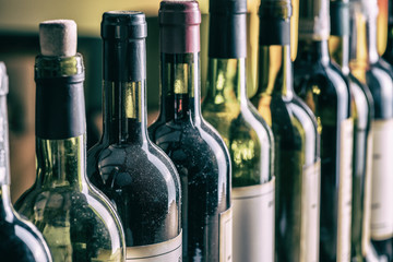 Line of wine bottles. Close-up.
