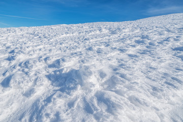 Fototapeta na wymiar Macro shot of snow texure. Snow cover in the mountains.