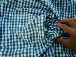 Women hand with Square pattern fabric background. Scott chintz fabric for design.Plaid cotton...