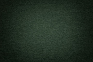 Fototapeta premium Texture of old dark green paper background, closeup. Structure of dense deep bluish cardboard.
