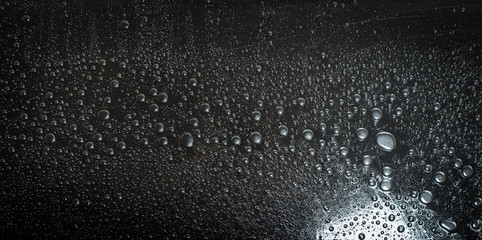 Water droplets on black background rain macro