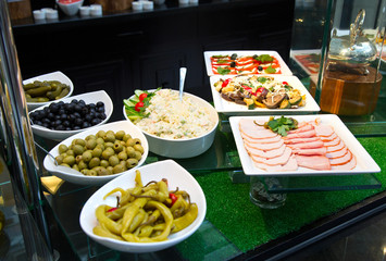 Salads and appetizers, Banquet table with delicious festive food. Variety of food and snacks