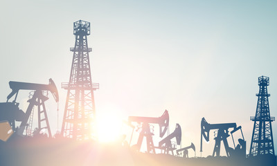 Oil field with derricks and pumpd over blue sky background. Vector illustration.