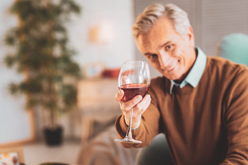 Man holding glass of French red wine in his hands