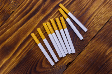Tobacco cigarettes on wooden table