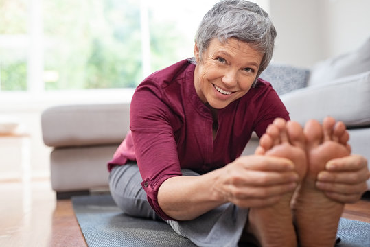 Mature woman doing stretching exercises