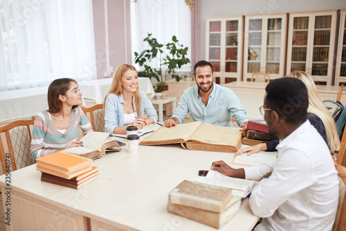 Multicultural Friends Socializing And Studying Together In - 