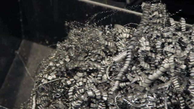 Metal chips fall after metalworking. Heap of metal shavings. Iron swarf