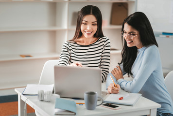 Young dark-haired woman wearing glasses making notes