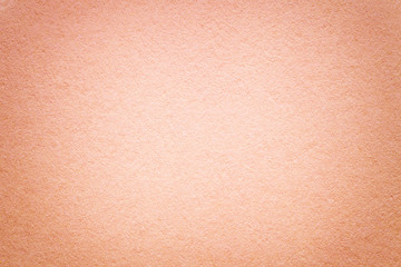 Texture of old coral paper background, closeup. Structure of dense cardboard.