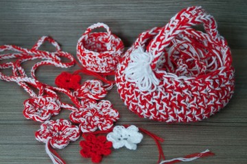 Martenitsa, white and red strains of yarn, Bulgarian folklore tradition, welcoming the spring in March, symbol, wish for good health. Crochet basket and flowers pendants. Baba Marta Day.
