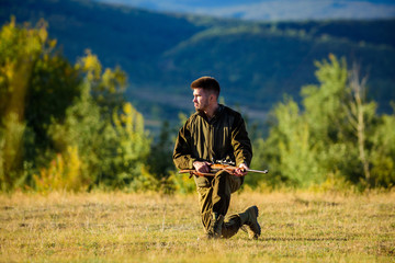 Naklejka na ściany i meble Man bearded hunter with rifle nature background. How turn hunting into hobby. Guy hunting nature environment. Masculine hobby activity. Hunting season. Experience and practice lends success hunting