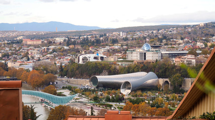 Panoramic view of Tbilisi, the capital of Georgia with old town and modern architecture at autumn. Bridge of peace, Kura river, presidential Palace and musical theatre. © Алексей Боев