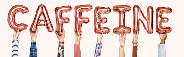 Hands holding caffeine word in balloon letters