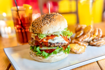 Tasty Juicy American Beef Burger Menu With Lettuce, Ketchup And Potato Chips In Fast-Food Restaurant