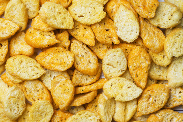 Croutons of white bread baguette with spices in dishes. Close up