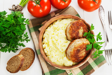 Cutlets and mashed potatoes in a ceramic plate