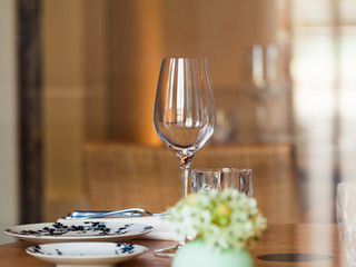Table setting in a French restaurant. View through a window from a street.