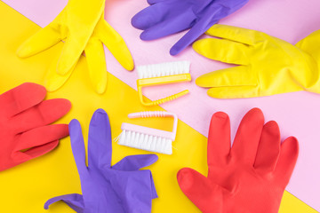 two cleaning brushes, surrounded by a set of multi-colored gloves to protect your hands, from damage by chemical cleaning agents