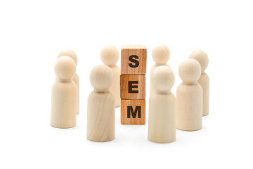 Wooden figures as business team in circle around acronym SEM Search Engine Marketing