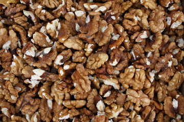 Full frame of peeled raw organic walnuts. Walnut background texture. Close up of nuts pattern. Walnuts wallpaper. Ripe and peeled walnut kernels