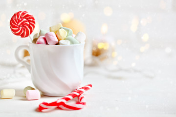 Merry Christmas and happy New year. Cup of cocoa and marshmallows on a light background. Christmas background.