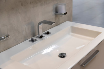 Fragment of bathroom with sink and faucet