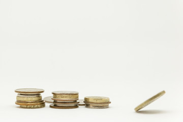 Three piles of coins and a spinning coin