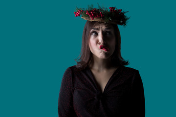 Girl with a wreath on her head posing with a funny face