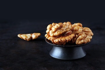 Walnut kernels on dark background, low key