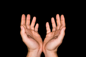 Fototapeta premium hands of a prayer on dark background. Croppped image