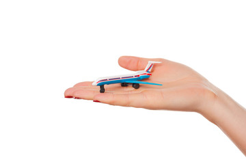 woman's hand holding toy airplane, isolated on white background