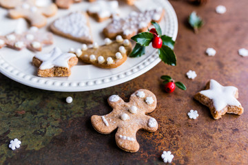 Homemade Christmas gingerbreads on a white plate. 