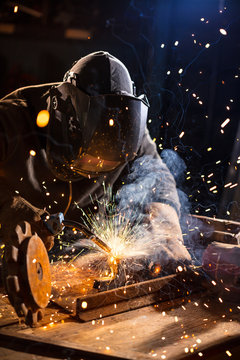 Welder working in workshop factory
