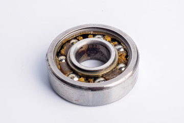 Used rusty metal ball bearing on white background.