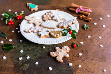 Homemade Christmas gingerbreads on a white plate. 