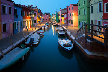 Fototapeta na wymiar Old colorful houses and boats at night in Burano, Venice Italy