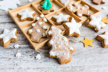Homemade Christmas gingerbreads on a wooden background.

