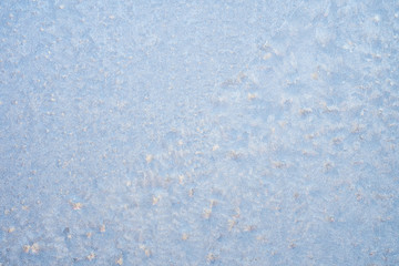 Frosty christmas pattern at a winter window glass