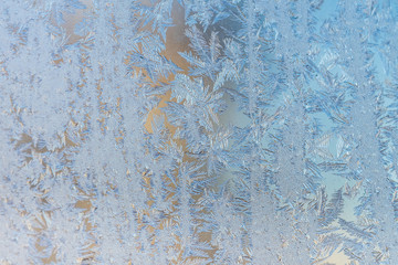 Frosty christmas pattern at a winter window glass