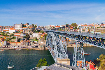 Panoramic landscape view on the old town with Douro river and famous iron bridge in Porto city in Portugal