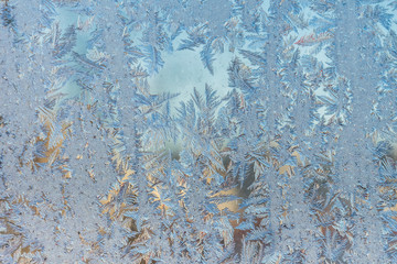The patterns made by the frost on the window. Frosty winter background photo