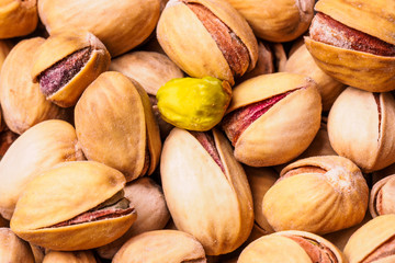 Close-up of pistachio. Selective focus on foreground.Pistachios texture. Nuts. Roasted salted pistachio nuts healthy delicious food studio photo.