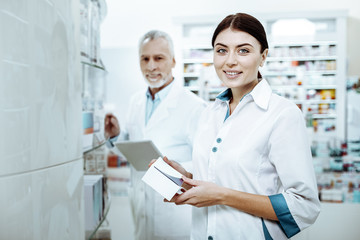 Positive delighted young female looking straight at camera