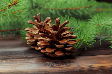 Fototapeta premium Christmas composition with fir tree branches on wooden background.