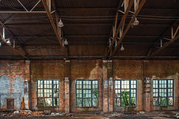 Large broken window in abandoned ruined industrial warehouse or factory building inside, ruins and...