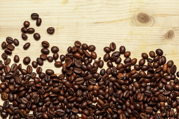 Close up of coffee beans on a wooden background