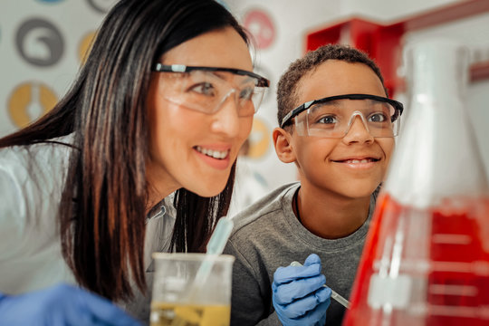 Happy young teacher enjoying her work with kids