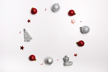 Christmas composition. Wreath of red balls, Santa's boot, Christmas tree and silver balls. Flat lay, top view