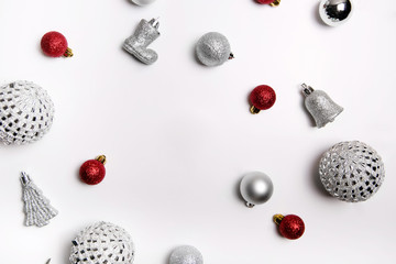 Christmas composition. Red balls, silver balls and decor on a white background. Flat lay, top view
